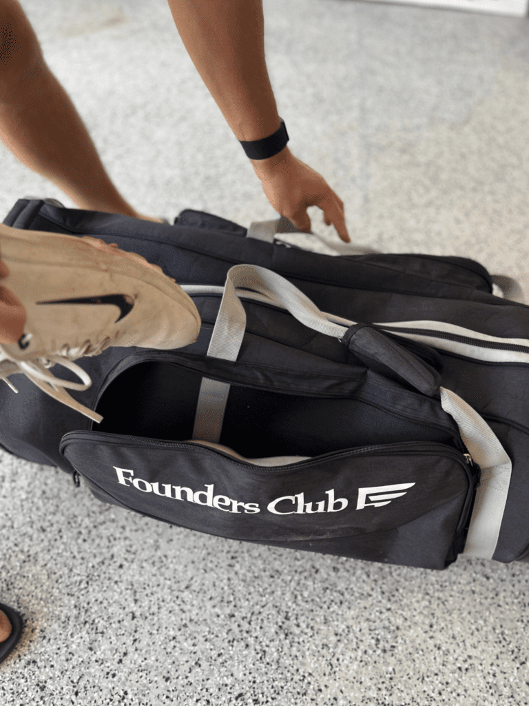 Image showcases the best golf travel bag called Founders club golf bag with side pockets with golf shoes and in line skate wheels